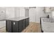 A kitchen island with a gray countertop and a white door at 222 S Oak Rd, Maricopa, AZ 85139