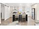 Modern kitchen featuring an island with seating, stainless steel appliances, and light wood flooring at 222 S Oak Rd, Maricopa, AZ 85139