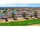 Aerial view of houses along a golf course with lush green grass and mature trees at 2284 Leisure World --, Mesa, AZ 85206