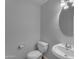 Cozy bathroom with a pedestal sink and matching white toilet at 2501 E Los Alamos St, Gilbert, AZ 85295