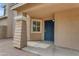 Inviting covered front porch featuring a steel security door and detailed trim work, offering a secure entry at 2501 E Los Alamos St, Gilbert, AZ 85295