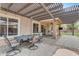 Comfortable covered patio featuring a built in ceiling fan, outdoor seating, and pavers at 2501 E Los Alamos St, Gilbert, AZ 85295