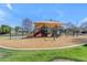 Community playground with a large sunshade and modern playground equipment, surrounded by lush green grass at 2501 E Los Alamos St, Gilbert, AZ 85295