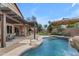 Enjoy the outdoors in this covered patio and pool with rock waterfall feature at 2501 E Los Alamos St, Gilbert, AZ 85295