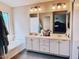 Bathroom featuring a bathtub and double sink vanity with large mirrors at 2542 S Rowen St, Mesa, AZ 85209