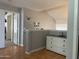 Hallway with neutral paint, laminate floors, and a white dresser at 2542 S Rowen St, Mesa, AZ 85209