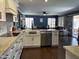 Open kitchen showcasing white cabinets, stainless appliances, and dark wood floors at 2542 S Rowen St, Mesa, AZ 85209