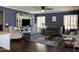 Comfortable living room featuring a ceiling fan, built-in shelving, and hardwood floors at 2542 S Rowen St, Mesa, AZ 85209