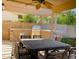 Outdoor kitchen features a built-in grill, dining table, and pergola with string lights at 2542 S Rowen St, Mesa, AZ 85209