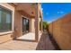 Covered back patio with brick pavers and desert landscaping beyond at 2565 S Signal Butte Rd # 8, Mesa, AZ 85209