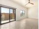 Sunny bedroom featuring a sliding glass door to a patio, a window, and tile floors at 2565 S Signal Butte Rd # 8, Mesa, AZ 85209