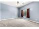 Empty bedroom with light blue walls, neutral carpet and a ceiling fan at 2565 S Signal Butte Rd # 8, Mesa, AZ 85209