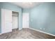 Bedroom features light blue walls, neutral carpeting, and a large closet with bi-fold doors at 2565 S Signal Butte Rd # 8, Mesa, AZ 85209