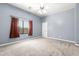 Spacious bedroom featuring neutral carpet, a window, and a modern ceiling fan at 2565 S Signal Butte Rd # 8, Mesa, AZ 85209