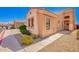 Exterior view of a single story home with stone facade, desert landscaping, and sidewalk at 2565 S Signal Butte Rd # 8, Mesa, AZ 85209