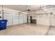 Spacious, clean garage with bright lighting, epoxy floors, and white walls at 2565 S Signal Butte Rd # 8, Mesa, AZ 85209