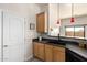 Bright kitchen area featuring warm cabinets and black appliances at 2565 S Signal Butte Rd # 8, Mesa, AZ 85209