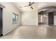 Bright living room featuring a tray ceiling, a ceiling fan, tile floors, and a large window at 2565 S Signal Butte Rd # 8, Mesa, AZ 85209