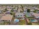 Wide aerial view showcasing the backyard oasis with a pool, sport court and mature trees at 2688 S Racine Ct, Gilbert, AZ 85295