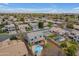 Expansive aerial view capturing a pool, sport court, lush landscaping, and surrounding neighborhood at 2688 S Racine Ct, Gilbert, AZ 85295