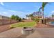 Expansive backyard featuring a brick firepit, mature landscaping, and block wall at 2688 S Racine Ct, Gilbert, AZ 85295