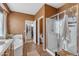 Bathroom featuring a glass shower, a bathtub, tiled floors, and doorway leading to a closet at 2688 S Racine Ct, Gilbert, AZ 85295