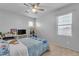 Well-lit bedroom with a cozy bed, window, and versatile shelving offering both style and functionality at 2688 S Racine Ct, Gilbert, AZ 85295