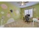 Bedroom with whimsical wall designs, a desk, fan, and neutral carpet creating a playful atmosphere at 2688 S Racine Ct, Gilbert, AZ 85295