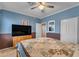 Comfortable bedroom with two-tone walls, ceiling fan, television and carpet flooring at 2688 S Racine Ct, Gilbert, AZ 85295