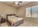 Bedroom featuring a ceiling fan, neutral walls, and a window with blinds and an outside view at 2688 S Racine Ct, Gilbert, AZ 85295