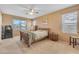 Bedroom with a wooden bed frame, carpet flooring, and large windows at 2688 S Racine Ct, Gilbert, AZ 85295