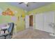 Bedroom with whimsical wall designs, closet and neutral carpet creating a playful atmosphere at 2688 S Racine Ct, Gilbert, AZ 85295