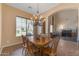 Dining room features a wooden table, chandelier, and a large window overlooking the neighborhood at 2688 S Racine Ct, Gilbert, AZ 85295