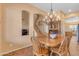 Charming dining room boasts a wooden table, chandelier, and an arched hallway to stairs at 2688 S Racine Ct, Gilbert, AZ 85295