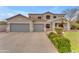 Charming two-story home featuring a two-car garage, desert landscaping and mature palm trees at 2688 S Racine Ct, Gilbert, AZ 85295