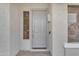 Close-up of a gray front door, complemented by decorative windows and a modern exterior design at 2688 S Racine Ct, Gilbert, AZ 85295