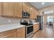 Well-lit kitchen featuring stainless steel appliances, quartz countertops, and ample cabinet space at 2688 S Racine Ct, Gilbert, AZ 85295