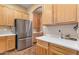 Bright kitchen featuring a stainless steel refrigerator and plenty of wooden cabinets at 2688 S Racine Ct, Gilbert, AZ 85295