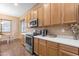 Well-lit kitchen features wooden cabinets, stainless steel appliances, and tile flooring at 2688 S Racine Ct, Gilbert, AZ 85295