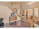 Spacious living room with hardwood floors, a staircase, and a view of the dining area, creating an open and airy feel at 2688 S Racine Ct, Gilbert, AZ 85295