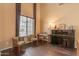 Bright living room featuring hardwood floors, a large window, and elegant furnishings, offering a cozy and stylish atmosphere at 2688 S Racine Ct, Gilbert, AZ 85295