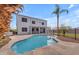 Inviting backyard pool with stone surround and view of the two-story home and patio at 2688 S Racine Ct, Gilbert, AZ 85295