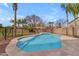 Sparkling pool with baja shelf, surrounded by lush landscaping and mature trees at 2688 S Racine Ct, Gilbert, AZ 85295