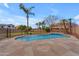 Sparkling blue pool surrounded by flagstone, with views of swaying palm trees at 2688 S Racine Ct, Gilbert, AZ 85295