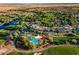 Aerial view of a community with mature landscaping, winding walking paths, and a resort style community pool at 28516 N 128Th Dr, Peoria, AZ 85383