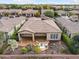 Aerial view of the house showcasing desert landscaping, covered patio, and neighborhood at 28516 N 128Th Dr, Peoria, AZ 85383