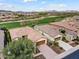 Aerial view of home showcasing a tile roof, desert landscape, and views of the golf course and mountains at 28516 N 128Th Dr, Peoria, AZ 85383