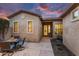 Cozy backyard with a covered patio, outdoor dining set and manicured greenery create a serene outdoor living space at 28516 N 128Th Dr, Peoria, AZ 85383