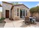 Attractive backyard patio with stone accents, featuring an outdoor table set for al fresco dining, perfect for entertaining at 28516 N 128Th Dr, Peoria, AZ 85383