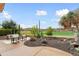 Lovely backyard featuring desert landscaping, comfortable seating area, and an open view of the golf course at 28516 N 128Th Dr, Peoria, AZ 85383